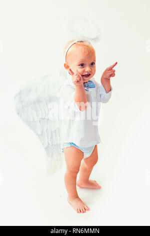 Merry Christmas to you. Christmas angel. Little boy with angel wings and halo. Baby angel. Adorable little angel boy. Cute valentines cupid or cherub Stock Photo