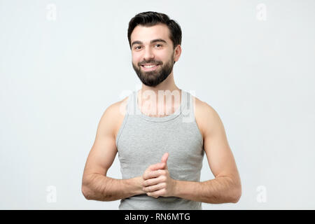 Smiling handsome man in singlet standing smiling Stock Photo