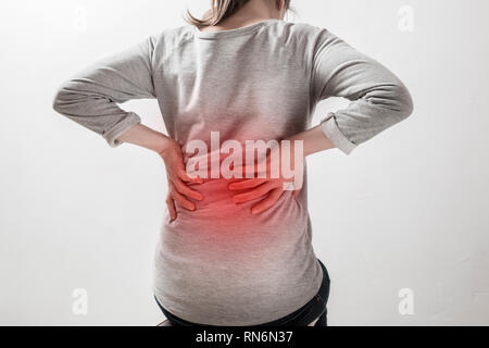 Pain in the kidneys. Women holding their hands behind their backs. Stock Photo