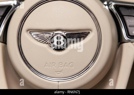 Novosibirsk, Russia - 08.01.18: Interior view with emblem on steering wheel of luxury very expensive new black Bentley Bentayga car stands in the wash Stock Photo