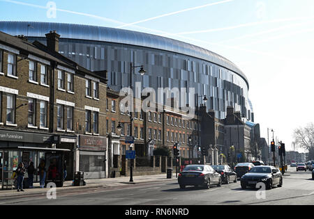 Tottenham London UK February 2019 -  The new Tottenham Hotspur Stadium towers above the surrounding buildings including Percy House in the High Rd Stock Photo