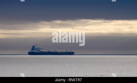 Commercial ship anchored off the coast Stock Photo