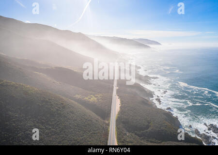 Aerial View Drone Shot of Highway Pacific Coast Highway California USA Big Sur Mountains Ocean Fog Stock Photo