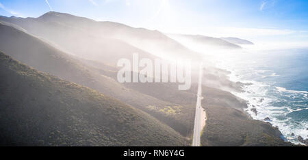 Aerial View Drone Shot of Highway Pacific Coast Highway California USA Big Sur Mountains Ocean Fog Stock Photo