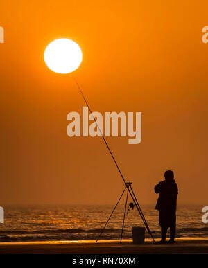 An angler competes in Europe's largest beach angling festival at the Paul Roggeman European Open Beach Championship, in East Riding in Yorkshire. Stock Photo