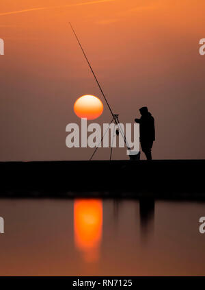 An angler competes in Europe's largest beach angling festival at the Paul Roggeman European Open Beach Championship, in East Riding in Yorkshire. Stock Photo