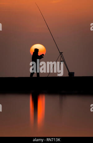 An angler competes in Europe's largest beach angling festival at the Paul Roggeman European Open Beach Championship, in East Riding in Yorkshire. Stock Photo