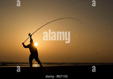 An angler competes in Europe's largest beach angling festival at the Paul Roggeman European Open Beach Championship, in East Riding in Yorkshire. Stock Photo