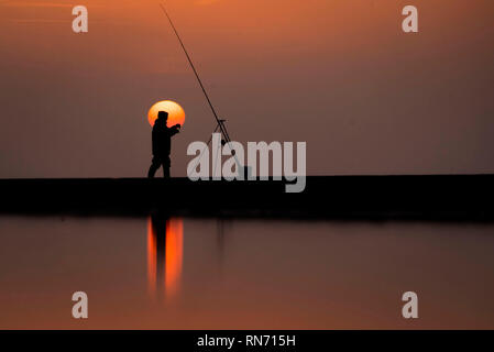 An angler competes in Europe's largest beach angling festival at the Paul Roggeman European Open Beach Championship, in East Riding in Yorkshire. Stock Photo