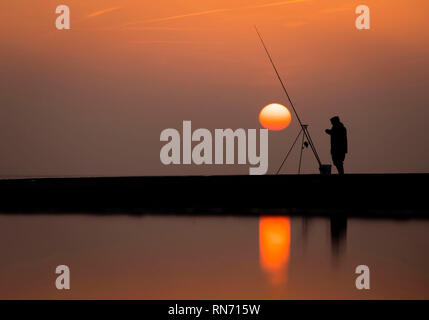 An angler competes in Europe's largest beach angling festival at the Paul Roggeman European Open Beach Championship, in East Riding in Yorkshire. Stock Photo