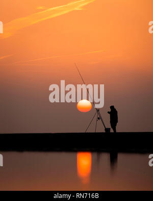 An angler competes in Europe's largest beach angling festival at the Paul Roggeman European Open Beach Championship, in East Riding in Yorkshire. Stock Photo