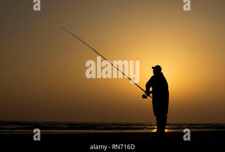 An angler competes in Europe's largest beach angling festival at the Paul Roggeman European Open Beach Championship, in East Riding in Yorkshire. Stock Photo