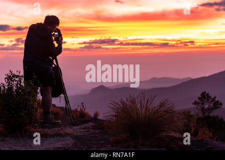 Sunrise viewpoint photographer On the high mountain, Thailand Stock Photo