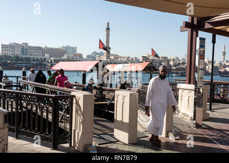 Local residents using water taxis arrive at one of the landing stages on the Creek in Dubai in the United Arab Emirates, (UAE) Stock Photo