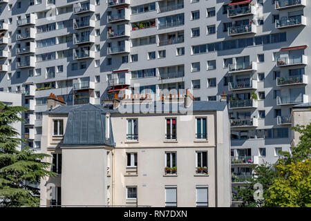 A house in Paris dwarfed by a large apartment block in the 12th arrondissement of Paris,France Stock Photo