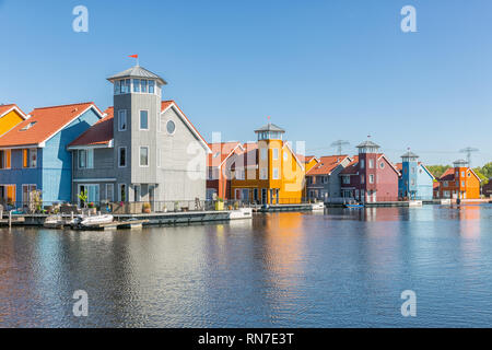Waterfront with colorful wooden houses in Dutch Reitdiep harbor, Groningen Stock Photo