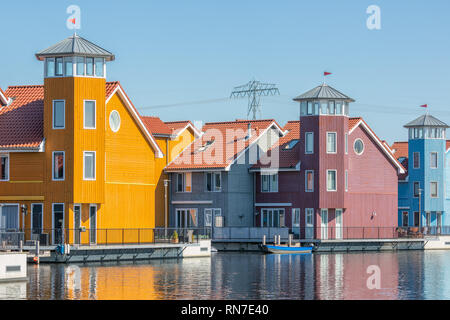 Waterfront with colorful wooden houses in Dutch Reitdiep harbor, Groningen Stock Photo