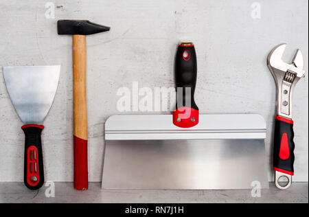 Construction tools are located on a light concrete background Stock Photo
