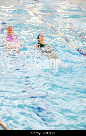 Two Women Swimming in Pool Stock Photo