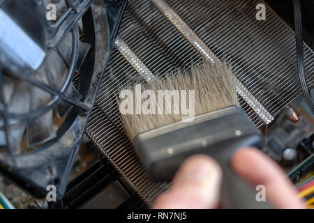 desktop computer dust cleaning with tassel. cpu cooling radiator system with dust and web. Stock Photo