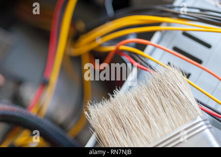 desktop computer dust cleaning with tassel. computer power wires. Stock Photo