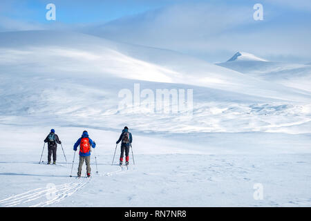 Group of ski-mountaineers ski touring on the Feshie plateau in the Cairngorm mountains, Scotland,UK Stock Photo
