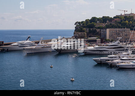 View from the Yacht Club de Monaco at super yachts docked in the port Hercules in Monaco Stock Photo