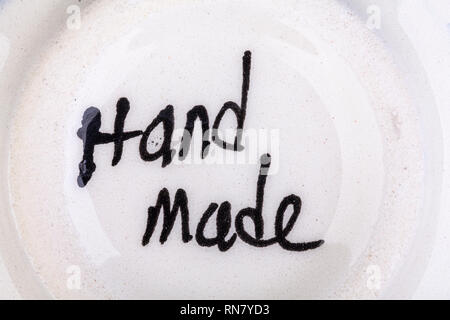 Hand made sign on the bottom of a dish Stock Photo