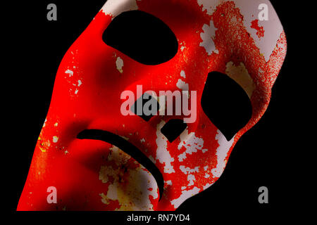Blank robot face with red grunge texture for skin. AI concept with close up human like features. Black background. Stock Photo