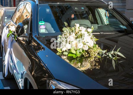 France, wedding bouquet with white flowers on the bonnet of a black car, Stock Photo