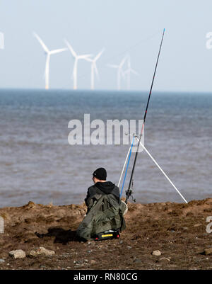 An angler competes in Europe's largest beach angling festival, the Paul Roggeman European Open Beach Championship, in the East Riding of Yorkshire. Stock Photo