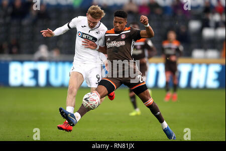 Swansea City's Oliver McBurnie (left) and Brentford's Julian Jeanvier battle for the ball during the FA Cup fifth round match at the Liberty Stadium, Swansea. Stock Photo