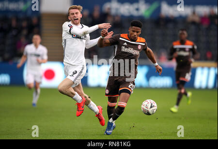 Swansea City's Oliver McBurnie (left) and Brentford's Julian Jeanvier battle for the ball during the FA Cup fifth round match at the Liberty Stadium, Swansea. Stock Photo