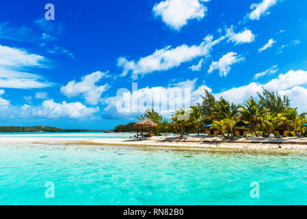 Stunning tropical Aitutaki island with palm trees, white sand, turquoise ocean water and blue sky at Cook Islands, South Pacific. Copy space for text Stock Photo