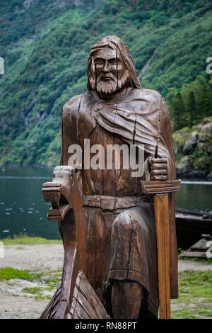 Wooden sculpture norse viking sailor with mountain and forests in background. Stock Photo