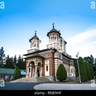 Romanian medieval christian church in a monastery in Sinaia Romania, with large empty blue sky. Stock Photo