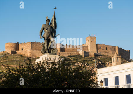 The statue of Hernan Cortes with castle of Medellin in the background, Extremadura, Spain. Stock Photo