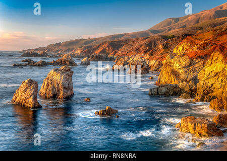 Crashing waves of water on the granite coastline of Garrapata State Park in California's Central Coast. Stock Photo