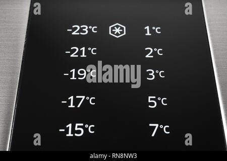 Closeup of modern steel colored fridge and freezer control panel. Internet of things abstract concept. Stock Photo