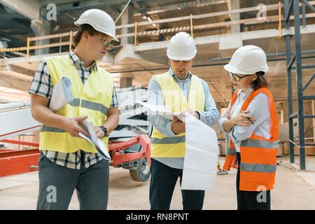 Female construction inspector examining construction site. Building, development, teamwork and people concept. Stock Photo