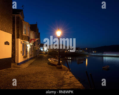 An evening shop taken looking down Bayard’s Cove in Dartmouth, South Devon. Stock Photo