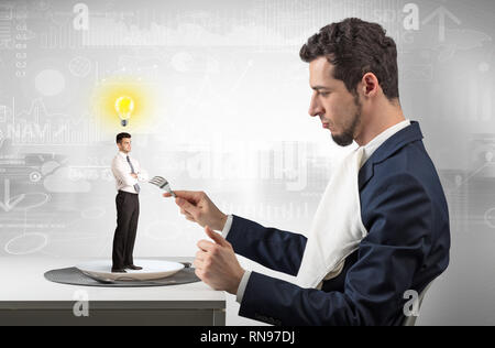 Giant businessman eating small man with financial background  Stock Photo