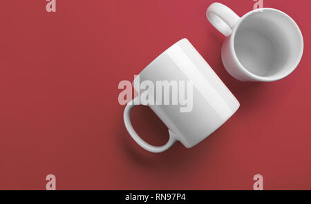 Side and top of white mugs on coral color background Stock Photo