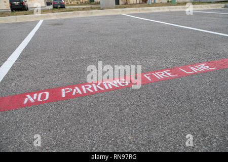 Close Up View of No Parking Painted on Concrete Stock Photo