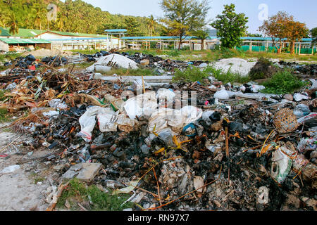 Pile of burned garbage in Ton Sai village on on Phi Phi Don Island, Krabi Province, Thailand. Koh Phi Phi Don is part of a marine national park. Stock Photo