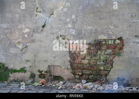 Plaster Missing from Wall Showing Brickwork Underneath Stock Photo