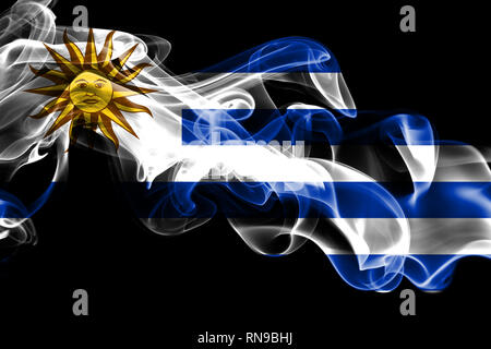 National flag of Uruguay made from colored smoke isolated on black background. Abstract silky wave background Stock Photo