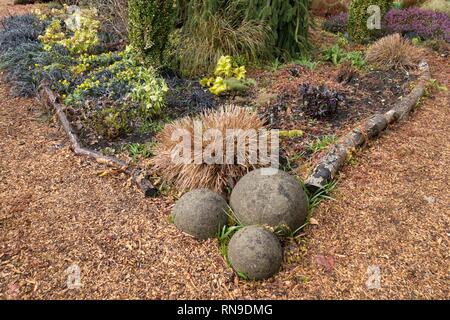 A garden with three round cornerstones. Stock Photo