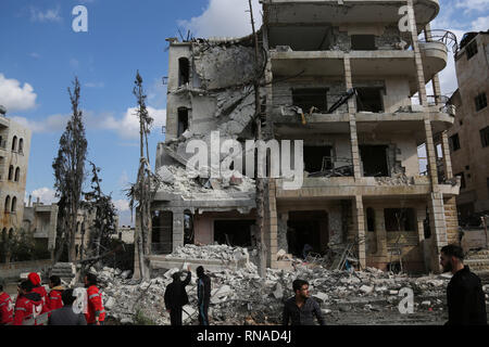 Idlib, Syria. 18th Feb, 2019. Syrians inspect the damage after two bomb ...