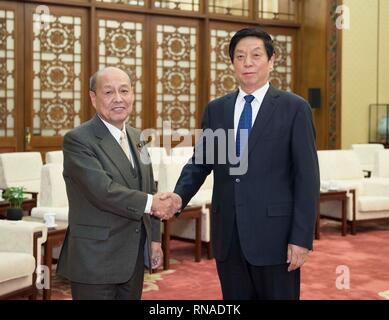 Beijing, China. 18th Feb, 2019. Li Zhanshu (R), chairman of the National People's Congress (NPC) Standing Committee, shakes hands with Ninoyu Satoshi, a member of Japan's House of Councillors who heads a delegation consisting of several members of Japan's House of Councillors, at the Great Hall of the People in Beijing, capital of China, Feb. 18, 2019. The delegation was in Beijng to attend the eighth meeting of the mechanism for regular exchanges between China's top legislature and the upper house of the National Diet of Japan. Credit: Li Tao/Xinhua/Alamy Live News Stock Photo